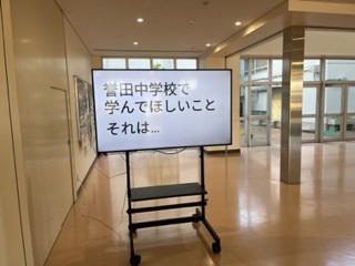 大型モニターに「誉田中学校で学んでほしいこと それは…」の文章が映し出されている写真